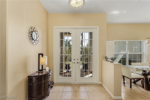 doorway featuring light tile patterned flooring and french doors