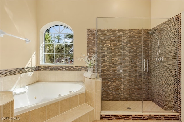 bathroom featuring separate shower and tub