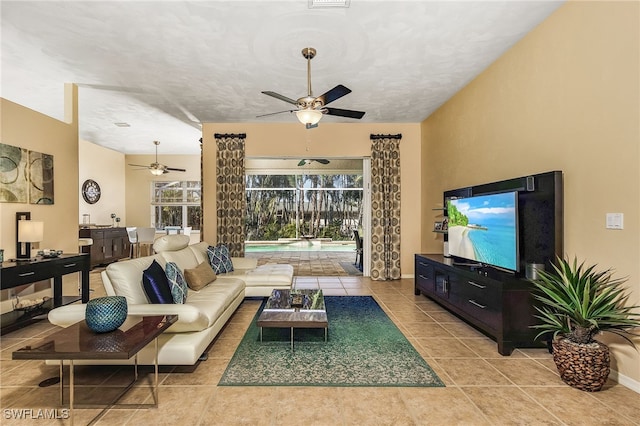 living room with ceiling fan and light tile patterned floors