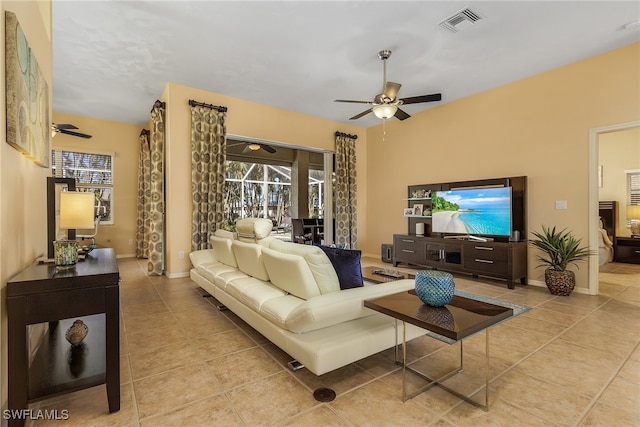 tiled living room with ceiling fan