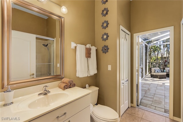 bathroom with walk in shower, vanity, tile patterned flooring, and toilet