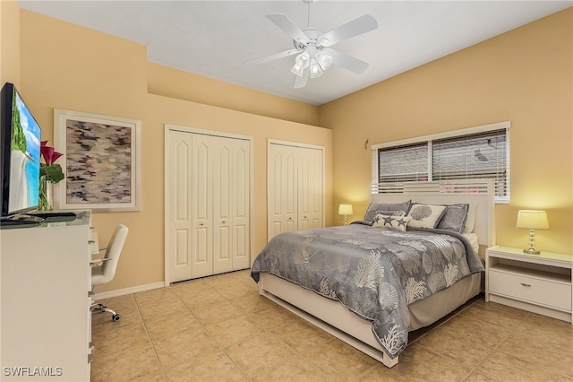 bedroom with ceiling fan, multiple closets, and multiple windows