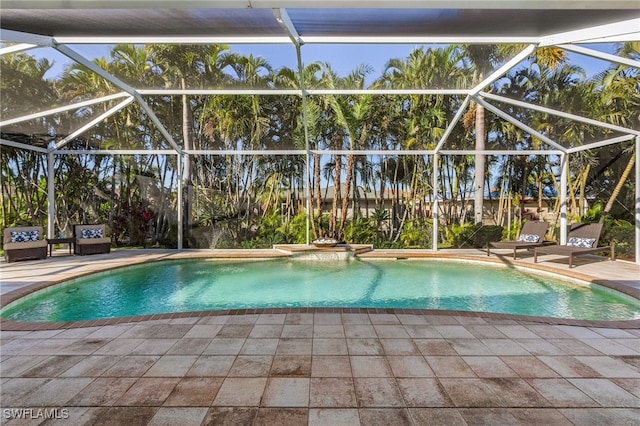 view of swimming pool with a patio and glass enclosure