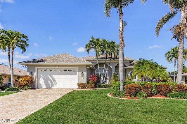 view of front facade featuring a front lawn and a garage