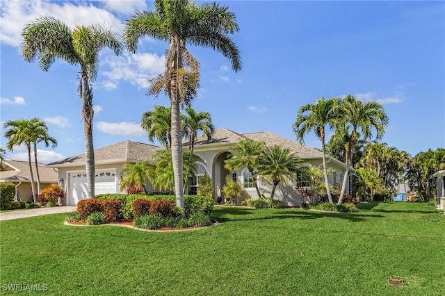 view of front of house featuring a front yard and a garage