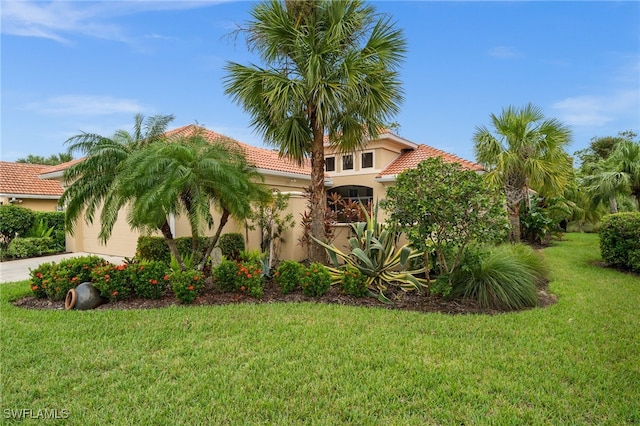 view of front facade featuring a front yard and a garage