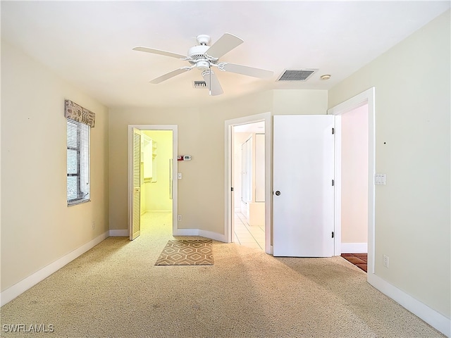 carpeted empty room featuring ceiling fan