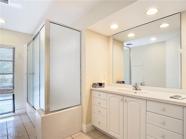 bathroom featuring an enclosed shower, tile patterned flooring, and vanity