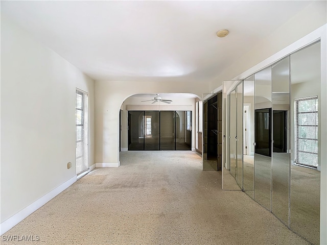 carpeted spare room with ceiling fan and a healthy amount of sunlight