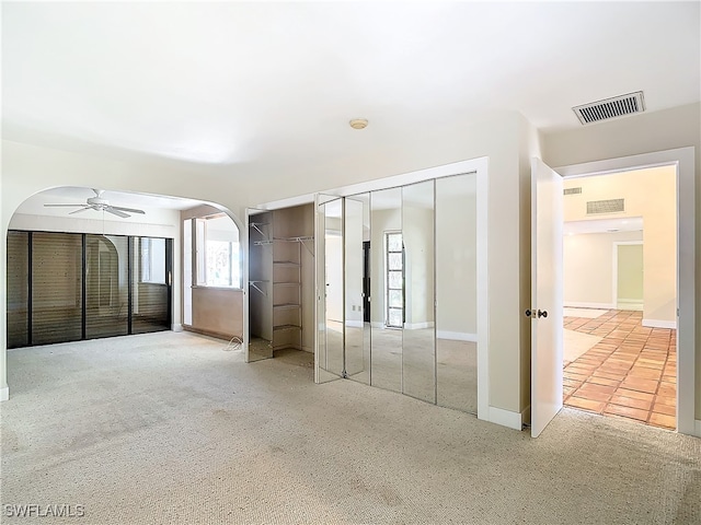 unfurnished bedroom featuring ceiling fan and carpet flooring