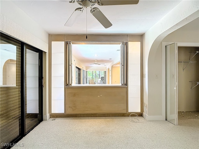 interior space with ceiling fan and carpet floors