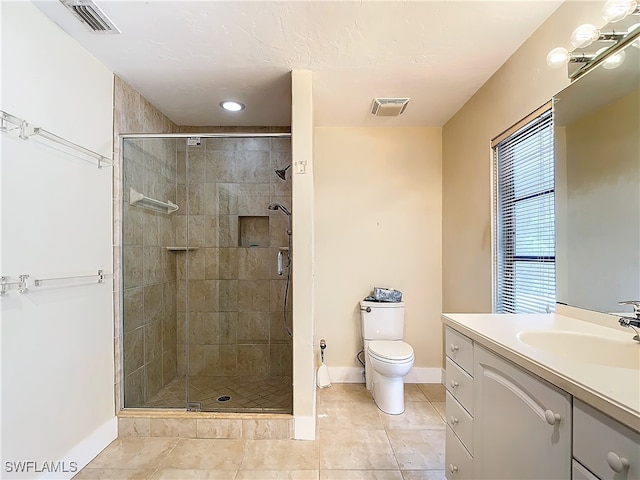 bathroom with tile patterned floors, toilet, walk in shower, and vanity