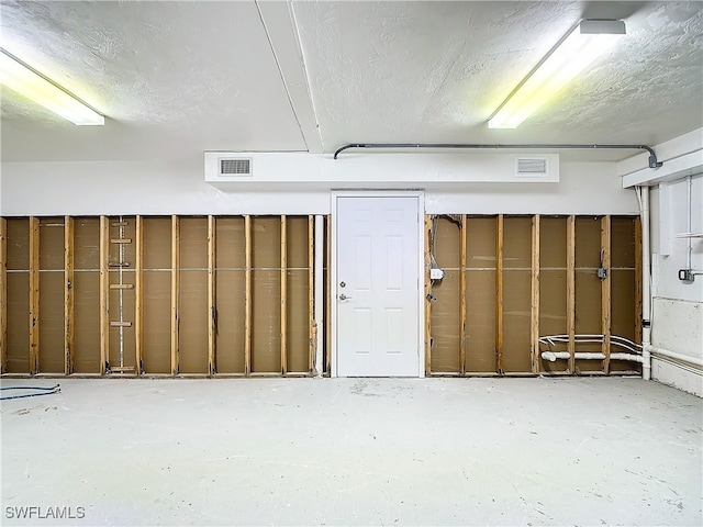 basement featuring a textured ceiling