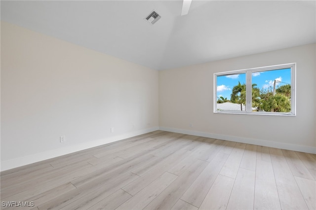 unfurnished room with light hardwood / wood-style floors and vaulted ceiling