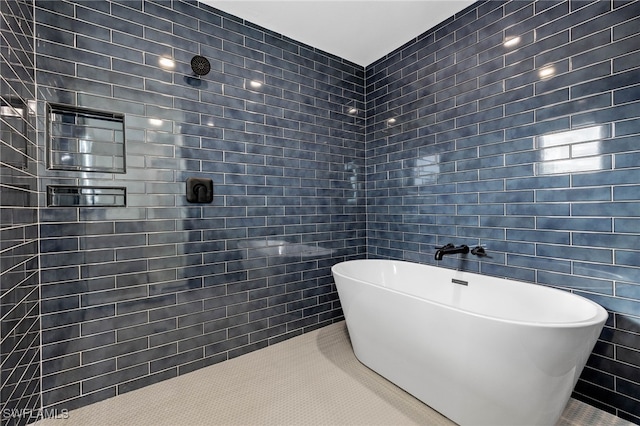 bathroom featuring tile patterned flooring, independent shower and bath, and tile walls