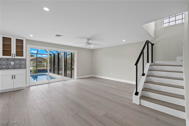 unfurnished living room featuring light hardwood / wood-style flooring and ceiling fan