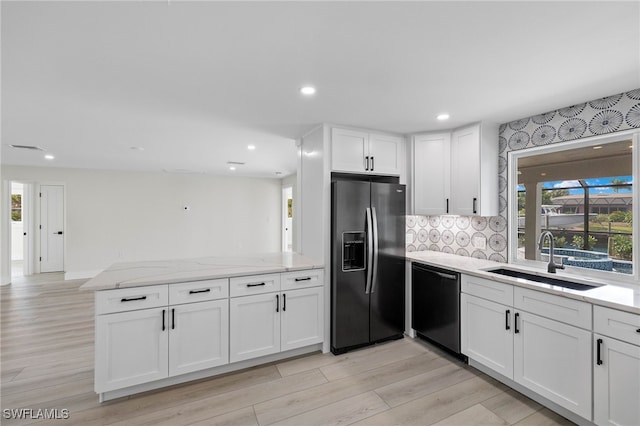 kitchen with stainless steel fridge, sink, light hardwood / wood-style flooring, white cabinetry, and dishwasher