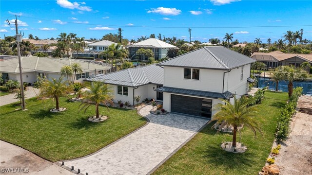 view of front of house with a front yard and a garage