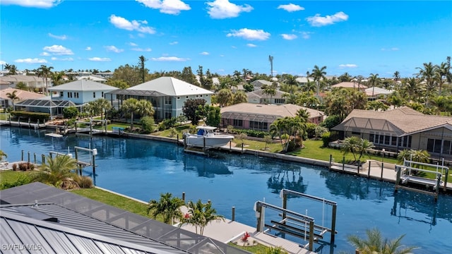 view of swimming pool with a water view and a boat dock