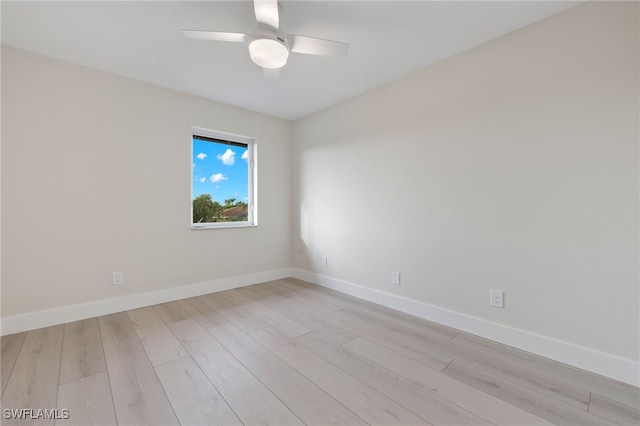 spare room with ceiling fan and light wood-type flooring