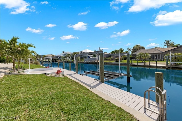 dock area with a water view and a lawn