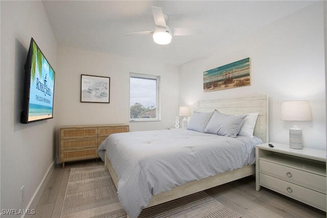 bedroom with ceiling fan and light wood-type flooring