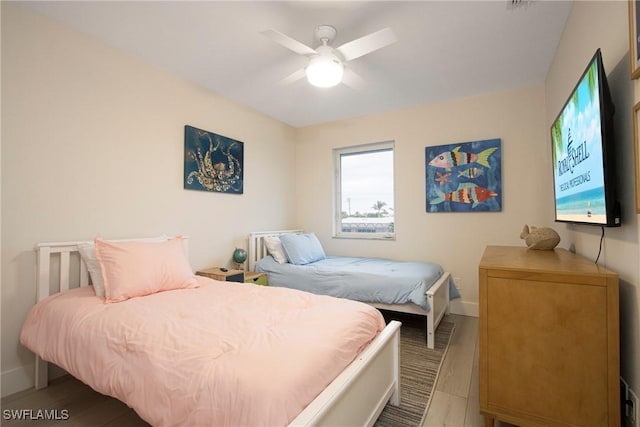 bedroom featuring wood-type flooring and ceiling fan