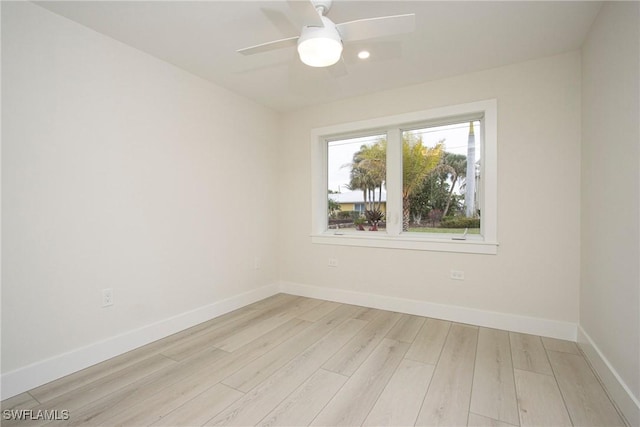 empty room featuring ceiling fan and light hardwood / wood-style floors