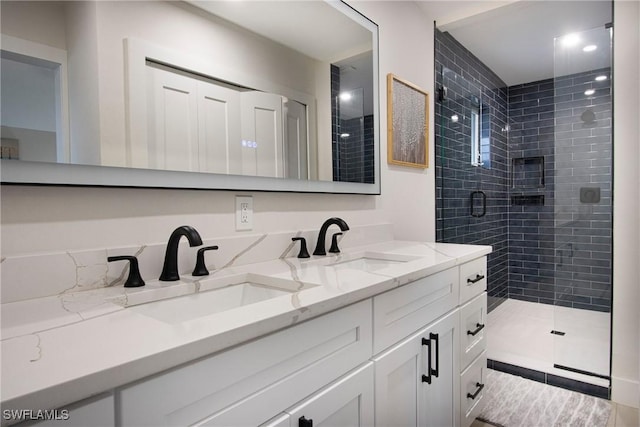 bathroom featuring vanity and a shower with shower door