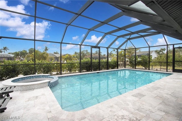 view of pool featuring an in ground hot tub, glass enclosure, and a patio area