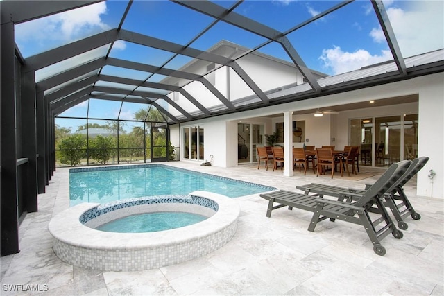 view of swimming pool featuring an in ground hot tub, a lanai, and a patio