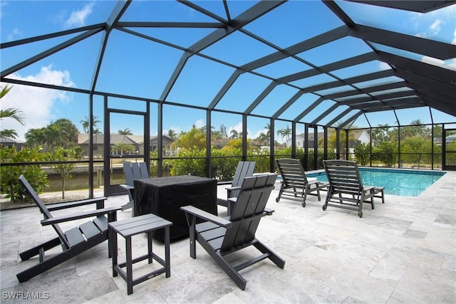 view of patio with glass enclosure