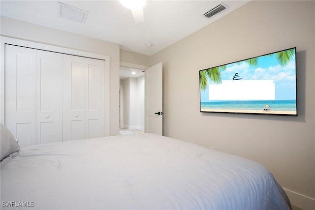 bedroom with ceiling fan and a closet