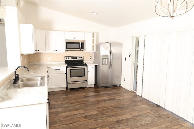 kitchen featuring stainless steel appliances, dark hardwood / wood-style floors, sink, and lofted ceiling