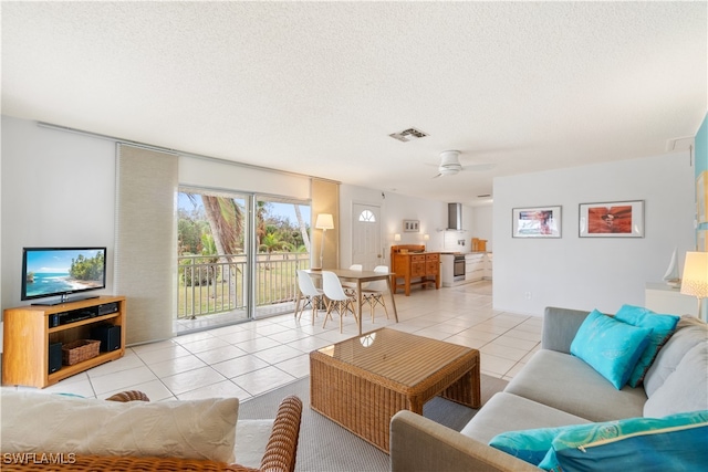 tiled living room with ceiling fan and a textured ceiling