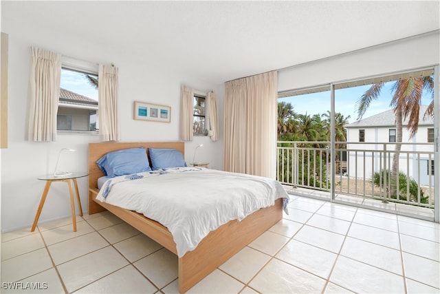 bedroom with access to outside and light tile patterned flooring