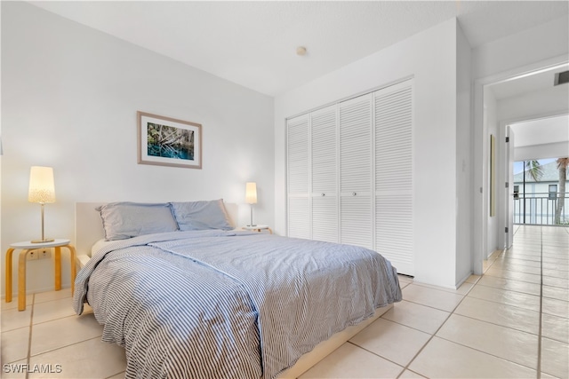 bedroom featuring light tile patterned floors and a closet