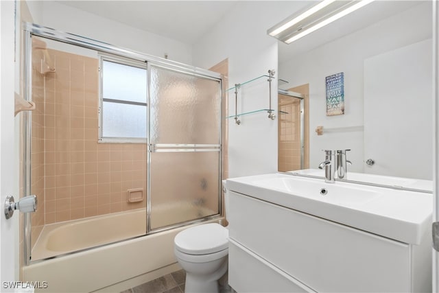 full bathroom with vanity, toilet, and enclosed tub / shower combo