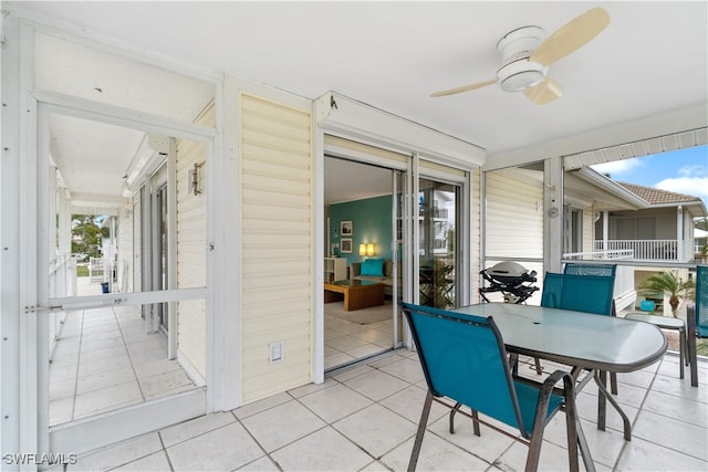 sunroom with plenty of natural light and ceiling fan