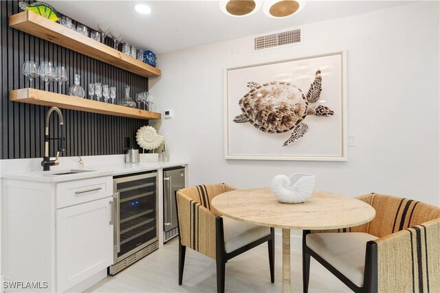 990 8th St S Unit 1B, Naples, FL 34102 - bar with beverage cooler, bar area, visible vents, and a sink