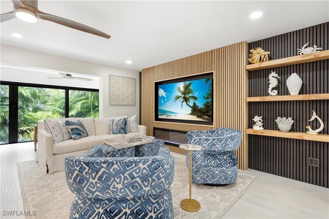 living room with ceiling fan and hardwood / wood-style floors