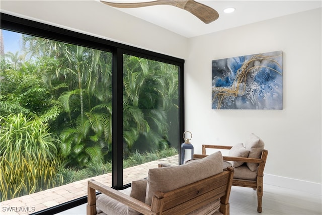 sitting room featuring hardwood / wood-style flooring and ceiling fan