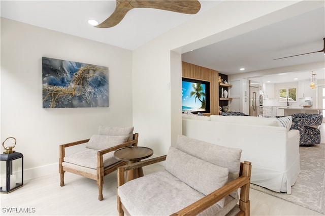 sitting room featuring ceiling fan and light hardwood / wood-style floors