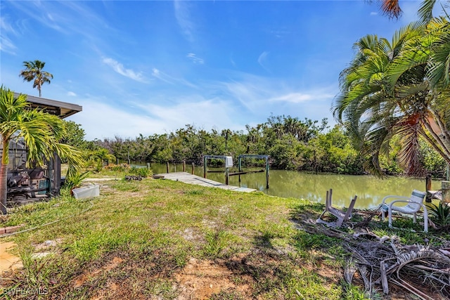 view of yard featuring a boat dock and a water view