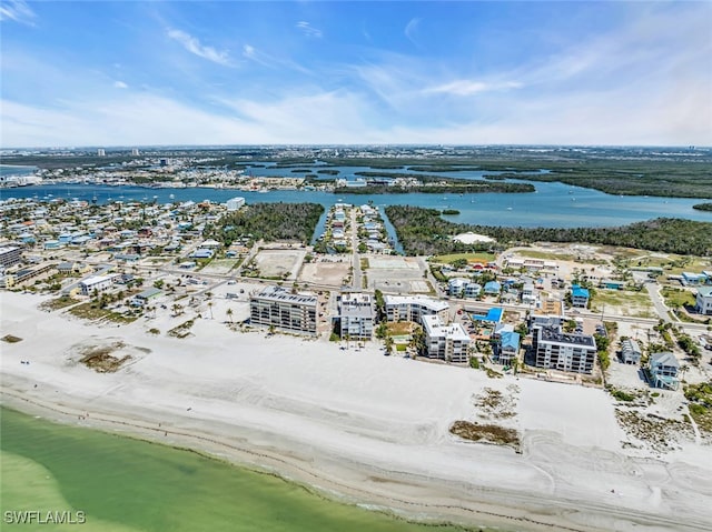 birds eye view of property with a water view and a beach view