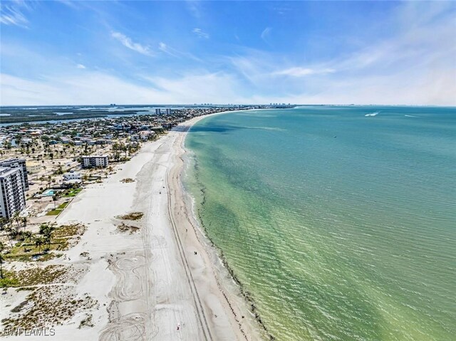 drone / aerial view featuring a water view and a beach view