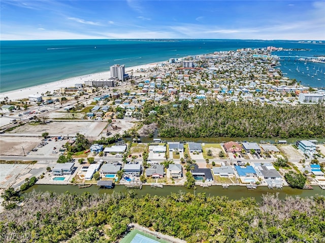 drone / aerial view with a water view and a beach view