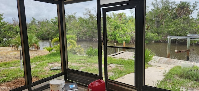 unfurnished sunroom featuring a water view and a healthy amount of sunlight