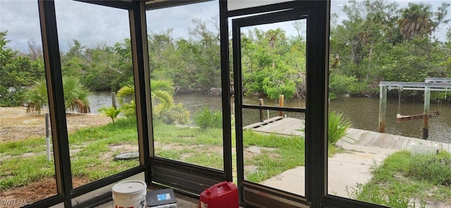 unfurnished sunroom featuring a water view