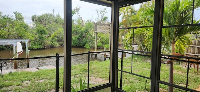 unfurnished sunroom featuring a water view and a healthy amount of sunlight